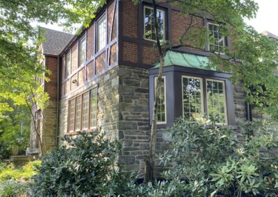 House exterior Philadelphia with white painted window trim and stone siding