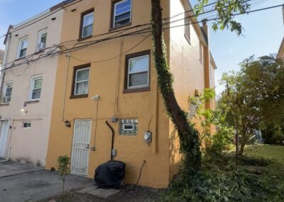 Completed warm ochre stucco exterior on the rear and side of a Philadelphia home