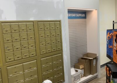 Painter preparing and coating walls beside post office boxes in Philadelphia, PA
