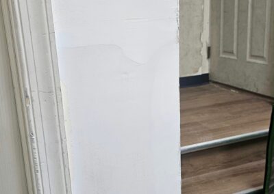 Freshly painted white hallway walls, doorway and stair trim in Philadelphia, PA