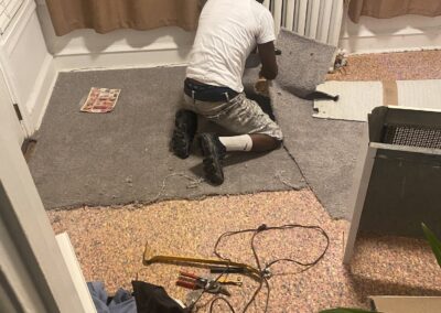 Painter protecting flooring and preparing an occupied room in Philadelphia, PA