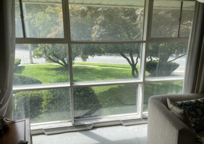 Living room picture window and trim before interior painting in Philadelphia, PA