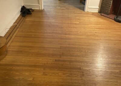 Refinished hardwood floor with freshly painted walls and trim in Philadelphia, PA