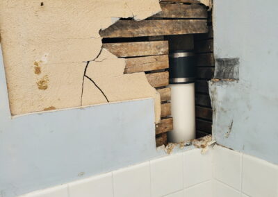 Bathroom plaster repair around plumbing and wood lath in a Philadelphia home