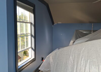 Blue bedroom interior painting with protected furniture in Philadelphia