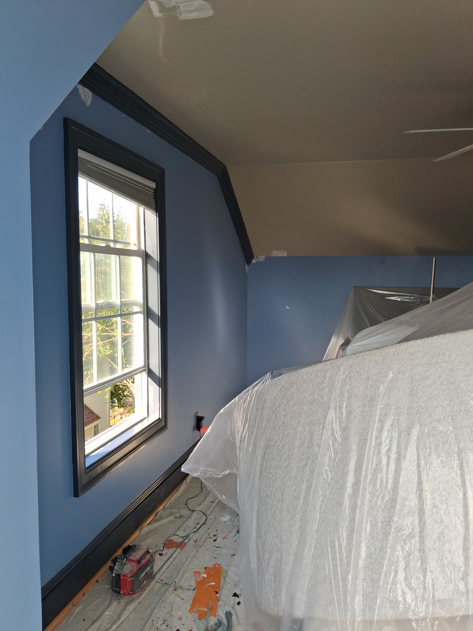 Blue bedroom interior painting with protected furniture in Philadelphia | Affordable Philly Painters Blue bedroom interior painting with protected furniture in Philadelphia