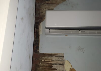 Plaster and wood lath wall repair around a mini split unit in Philadelphia