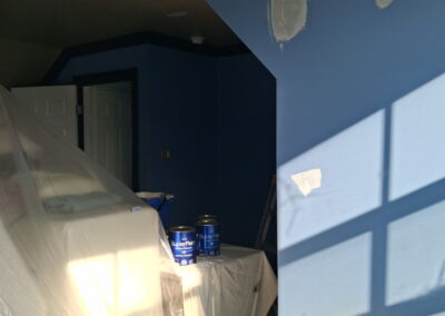 Blue interior room patching and painting with careful surface preparation