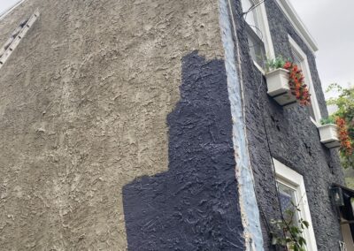 Exterior stucco painted navy blue on a Philadelphia rowhome - Umar Painting Company